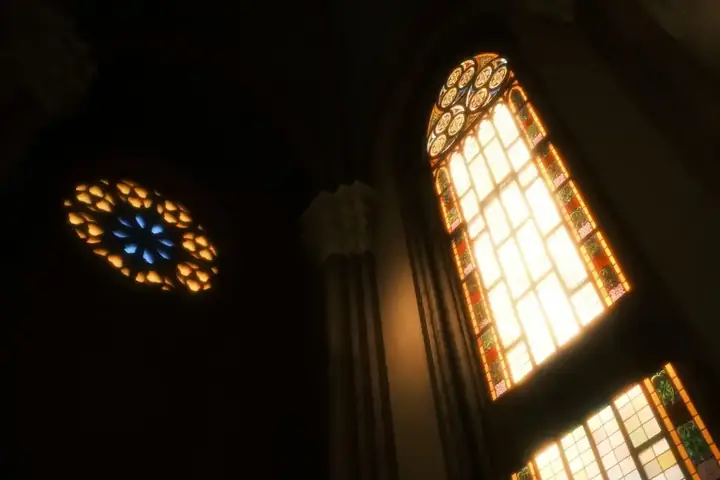 Light falling through the church windows onto the pews